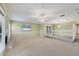 Spacious living room with a fireplace, large windows, and neutral decor at 4920 Kestral Park Cir # 11, Sarasota, FL 34231