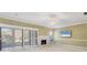 Bright living room features a fireplace, sliding glass doors with plantation shutters, and neutral decor at 4920 Kestral Park Cir # 11, Sarasota, FL 34231