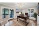Bright home office featuring a ceiling fan, wood floors, and a large desk with a laptop at 4920 Kestral Park Cir # 11, Sarasota, FL 34231