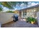 Charming brick patio with a grill and landscaping offers a private outdoor space for relaxation and entertaining at 4920 Kestral Park Cir # 11, Sarasota, FL 34231