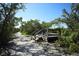 Wooded walking path with a scenic viewing platform overlooking a body of water, perfect for nature lovers at 4920 Kestral Park Cir # 11, Sarasota, FL 34231