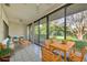 Bright and sunny sun room featuring tile floor, ceiling fan, and large sliding glass windows at 4920 Kestral Park Cir # 11, Sarasota, FL 34231