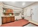 Functional utility room featuring ample storage with built-in shelves, a sink, and convenient access to the outdoors at 4920 Kestral Park Cir # 11, Sarasota, FL 34231