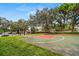 Community basketball court surrounded by mature trees and grassy areas, ideal for recreation at 5017 72Nd E Ct, Bradenton, FL 34203