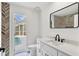 Bathroom with modern vanity, matte black hardware and view of the screened in pool area at 5017 72Nd E Ct, Bradenton, FL 34203