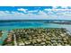 Beautiful aerial of waterfront property in a lush neighborhood, boasting tropical trees and landscaping near the gorgeous bay area at 526 Bird Key Dr, Sarasota, FL 34236