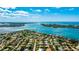 Stunning aerial view of a waterfront home in a lush community, featuring a beautiful pool and tropical landscaping at 526 Bird Key Dr, Sarasota, FL 34236