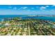 Expansive aerial view highlighting a residential neighborhood with waterfront access and lush greenery at 526 Bird Key Dr, Sarasota, FL 34236