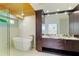 Elegant bathroom featuring a freestanding tub, walk-in shower, and stylish vanity with ample storage at 526 Bird Key Dr, Sarasota, FL 34236