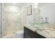 Modern bathroom featuring a walk-in shower, glass sink, and granite countertop at 526 Bird Key Dr, Sarasota, FL 34236