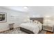 Inviting bedroom with a tufted headboard, soft lighting, and hardwood floors, creating a relaxing atmosphere at 526 Bird Key Dr, Sarasota, FL 34236