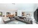 Spacious open-concept living area featuring modern decor, abundant natural light, and seamless flow to dining spaces at 526 Bird Key Dr, Sarasota, FL 34236