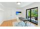 Office space features a desk, and a sliding glass door leading to the outside patio at 526 Bird Key Dr, Sarasota, FL 34236