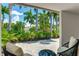 Back patio features lounge seating with beautiful views of the tropical landscaping at 526 Bird Key Dr, Sarasota, FL 34236