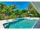 Gorgeous pool and spa surrounded by lush landscaping, offering a private and serene outdoor oasis at 526 Bird Key Dr, Sarasota, FL 34236