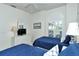 Bedroom featuring twin beds, nautical decor, and a window with shutter accents for filtered light at 5283 Chase Oaks Dr, Sarasota, FL 34241