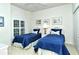 This bedroom features two twin beds with blue accents, complemented by nautical-themed wall art at 5283 Chase Oaks Dr, Sarasota, FL 34241