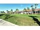 Beautiful home exteriors with screened lanais are landscaped with vibrant green lawns and towering palm trees at 5283 Chase Oaks Dr, Sarasota, FL 34241