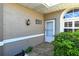 Inviting front porch with tiled floor, enhanced by charming details and lush green surroundings at 5283 Chase Oaks Dr, Sarasota, FL 34241