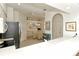 Bright kitchen featuring white cabinetry, tiled flooring, and an open dining area at 5283 Chase Oaks Dr, Sarasota, FL 34241