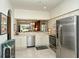 Bright kitchen with stainless steel appliances and an open view to the living area offers a modern touch at 5283 Chase Oaks Dr, Sarasota, FL 34241