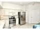 Well-equipped kitchen with updated stainless steel appliances and white cabinetry at 5283 Chase Oaks Dr, Sarasota, FL 34241