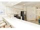 Kitchen with white countertops, bar seating, and stainless steel appliances at 5283 Chase Oaks Dr, Sarasota, FL 34241