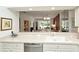 The kitchen features a large double sink and is open to the living area with a pass through counter at 5283 Chase Oaks Dr, Sarasota, FL 34241