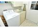 Convenient laundry room featuring a washer, dryer, and storage at 5283 Chase Oaks Dr, Sarasota, FL 34241