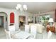 Bright living room boasts neutral carpet, complemented by a dining area and sliding glass doors to the patio at 5283 Chase Oaks Dr, Sarasota, FL 34241