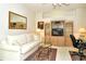 Comfortable living room featuring a cozy couch, entertainment center, and a decorative rug at 5283 Chase Oaks Dr, Sarasota, FL 34241