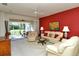 Bright living room boasts neutral carpet, complemented by a dining area and sliding glass doors to the patio at 5283 Chase Oaks Dr, Sarasota, FL 34241