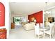 Bright living room boasts neutral carpet, complemented by a dining area and sliding glass doors to the patio at 5283 Chase Oaks Dr, Sarasota, FL 34241