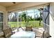 The screened lanai features lush golf course views and comfortable seating, ideal for relaxing outdoors at 5283 Chase Oaks Dr, Sarasota, FL 34241