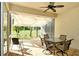 An enclosed lanai with sunshades features comfortable seating and views of the golf course at 5283 Chase Oaks Dr, Sarasota, FL 34241