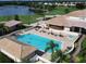 An aerial view of the inviting community pool, spa, and tanning deck surrounded by lush vegetation at 5283 Chase Oaks Dr, Sarasota, FL 34241