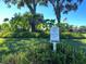 Walking trail entrance with signage surrounded by lush greenery, inviting residents to enjoy a walk at 5283 Chase Oaks Dr, Sarasota, FL 34241