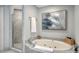 Bathroom featuring a bathtub and a separate glass shower with marble finishing at 535 Sanctuary Dr # A202, Longboat Key, FL 34228