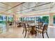 Bright dining area with wood floors, coffered ceilings, large windows, and table seating at 535 Sanctuary Dr # A202, Longboat Key, FL 34228