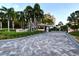 Community entrance with gatehouse and landscaping including palm trees at 535 Sanctuary Dr # A202, Longboat Key, FL 34228