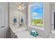 Bright bathroom featuring a vanity with a white countertop and a large window view of the outdoors at 5404 Spanish Moss Cv, Bradenton, FL 34203