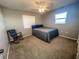 Simply decorated bedroom with a bed, rocking chair, and natural light from a window at 5513 Colony Lake Ln, Sarasota, FL 34233