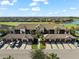 Aerial view of the condos with garages, driveways, landscaping and beautiful golf course and pond views at 5537 Palmer Cir # 205, Lakewood Ranch, FL 34211