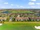 Scenic aerial view of the condo building with lush golf course, and beautiful community at 5537 Palmer Cir # 205, Lakewood Ranch, FL 34211