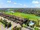 Beautiful aerial view of the condo building, golf course, and community pool at 5537 Palmer Cir # 205, Lakewood Ranch, FL 34211