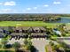 Aerial shot of condo building overlooking the community, lake and golf course with the pool in the background at 5537 Palmer Cir # 205, Lakewood Ranch, FL 34211
