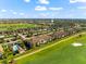 Aerial view of the condo building, golf course, and community amenity center at 5537 Palmer Cir # 205, Lakewood Ranch, FL 34211
