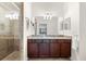 Elegant bathroom with a double sink vanity, granite counters, and glass enclosed shower at 5537 Palmer Cir # 205, Lakewood Ranch, FL 34211