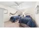 Comfortable bedroom with two twin beds, soft carpet, and a ceiling fan at 5537 Palmer Cir # 205, Lakewood Ranch, FL 34211