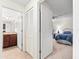 Inviting view of the Primary bedroom from the hallway featuring a ceiling fan and ensuite bathroom at 5537 Palmer Cir # 205, Lakewood Ranch, FL 34211